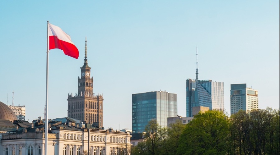 A city skyline of Warsaw with Polish flag in the foreground Poland