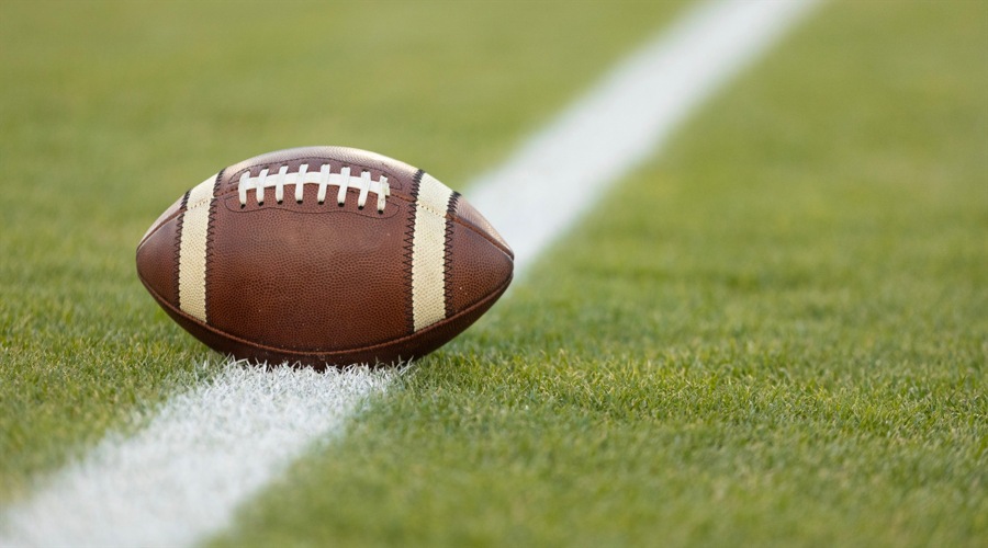 american football ball on the pitch