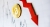 Bitcoin token laying on the candle chart with red downard arrow next to it