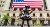 Fearless Girl Statue looking up at New York Stock Exchange building at Wall Street