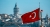Galata Tower and Turkish flag waving on the boat in the background.
