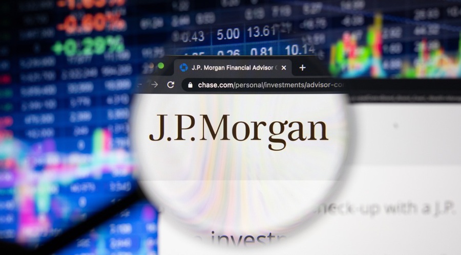 J.P.Morgan company logo on a website with blurry stock market developments in the background