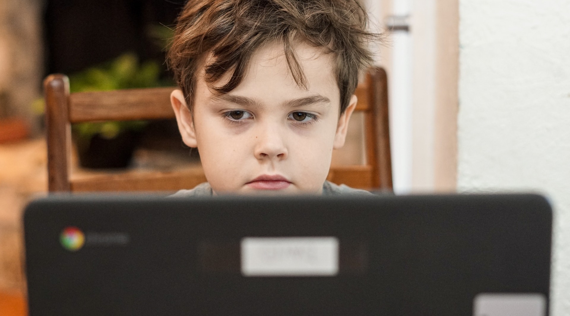 Kid by a computer