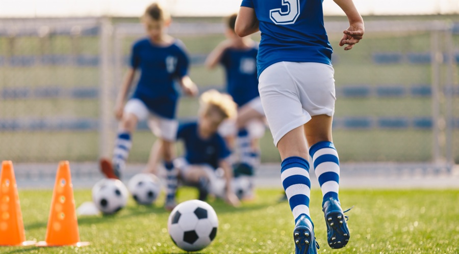Kids playing football (shutterstock)