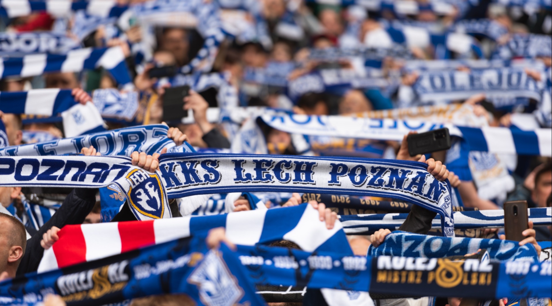 Lech Poznań fans scarfs with the club's name during a match