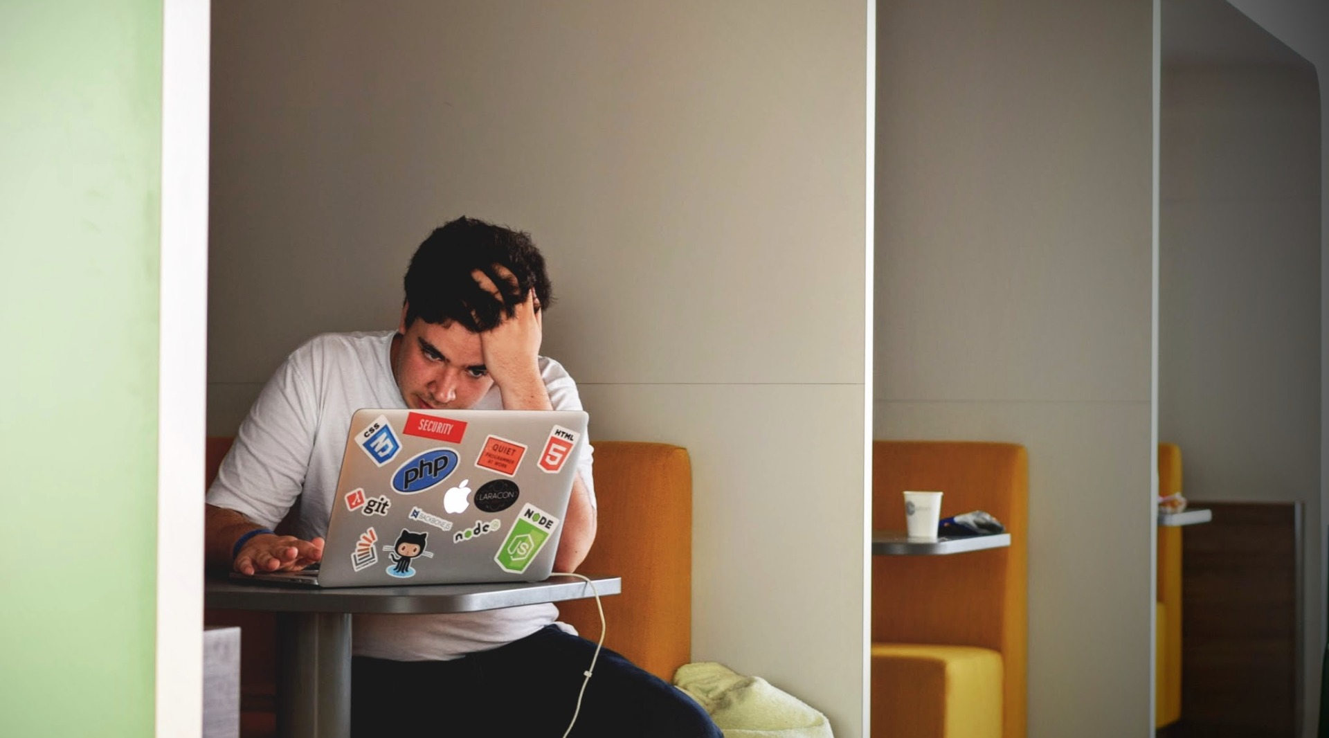 Man sitting next to his laptop computer