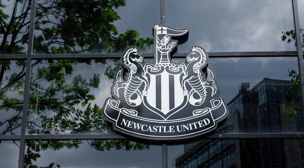 Newcastle United crest reflecting on glass building, Newcastle upon Tyne