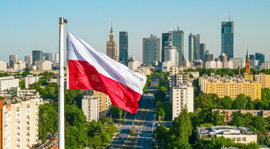Polish national white and red flag against skyscrapers in Warsaw city