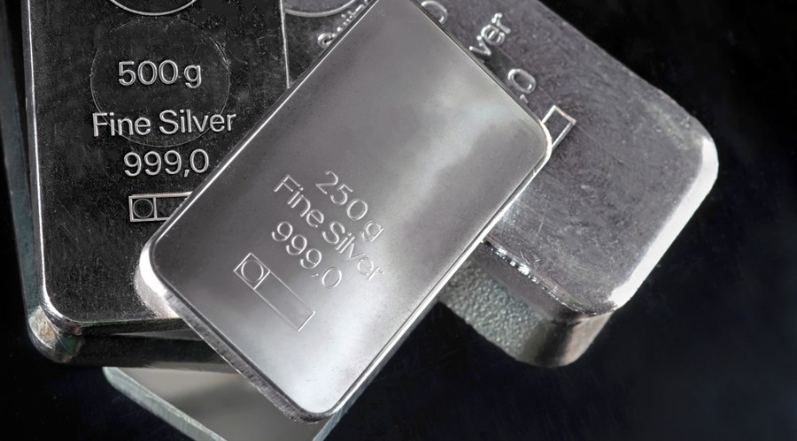 Several silver bars of various weights on a dark background