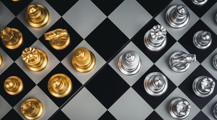 Top view of set of golden and silver chess pieces chessboard, close-up