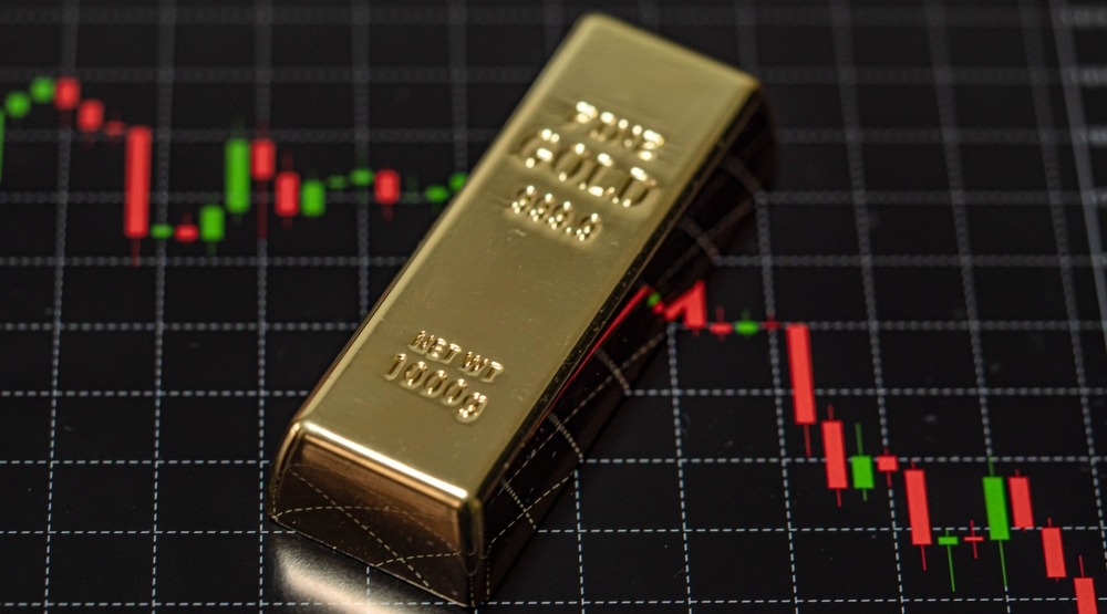 Prices are falling down and gold bar is laying on the chart