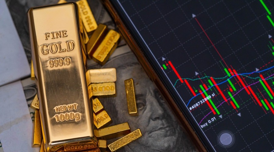 gold bars place on the phone that opens the candlestick chart. and dollar